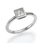 A sleek silver ring featuring a single square-cut gemstone set in a bezel setting.