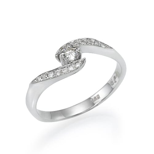 A silver ring with a unique twisting design featuring a central diamond and smaller diamonds inlaid along one of the twists.