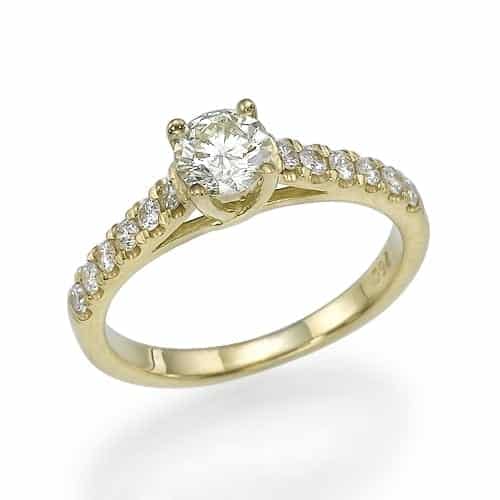 Gold engagement ring with a central round diamond flanked by smaller diamonds on the band.