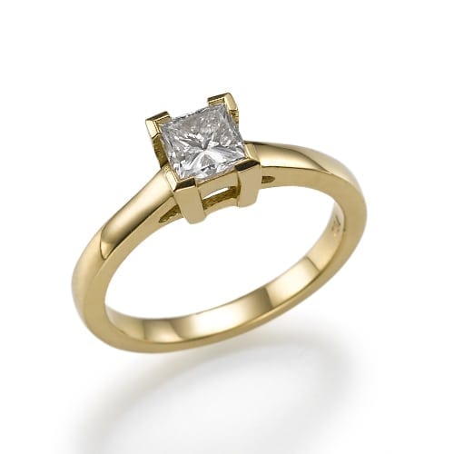 Elegant gold ring featuring a princess-cut diamond in a classic four-prong setting.