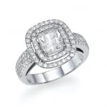 An elegant silver ring featuring a radiant-cut center diamond surrounded by a halo of smaller diamonds, with a pave-set diamond band, showcasing a luxurious and sophisticated design.