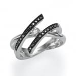 Silver ring with a central diamond and black accent stones in a swirling band design.