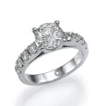 An elegant silver engagement ring featuring a large central diamond flanked by smaller diamonds set into the band.