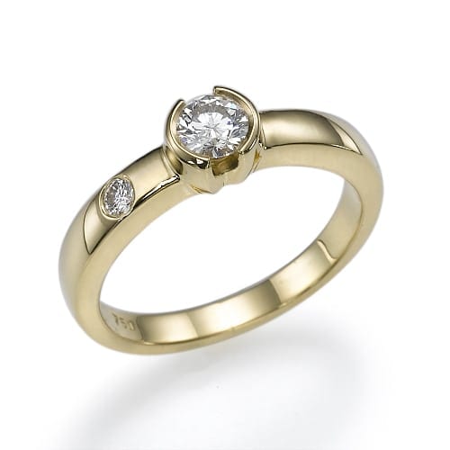 Elegant gold ring featuring a prominent central diamond with a smaller diamond set on the band.