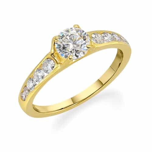 Elegant yellow gold engagement ring featuring a central round-cut diamond flanked by channel-set diamonds along the band.