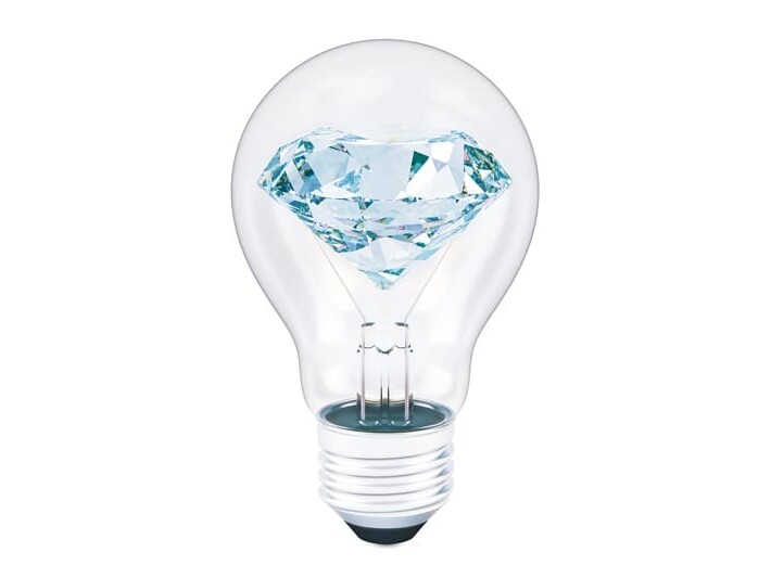 A brilliant diamond appears to illuminate the interior of a light bulb, symbolizing a fusion of creativity and value.