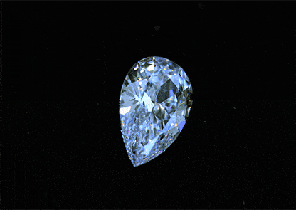 A sparkling pear-shaped diamond glistening against a black background.