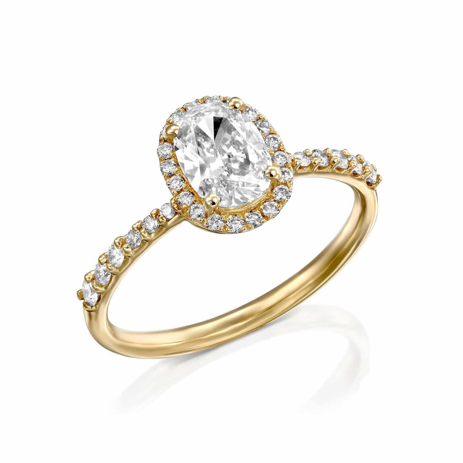 סיאל אלגנטי של טבעת אירוסין זהב הכולל יהלום מרכזי בצורת אגס מוקף בהילה של יהלומים עגולים קטנים יותר.